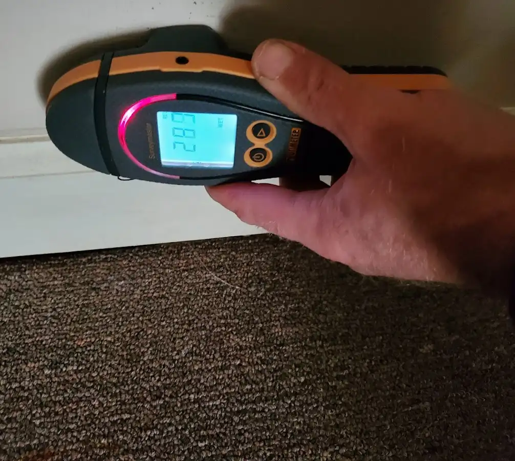 Moisture detection at baseboard during Storm Damage Restoration in Fulton
